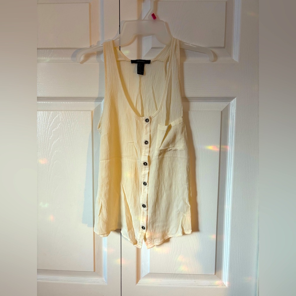 Women’s forever 21 size small button up sleeveless blouse with front pocket.
